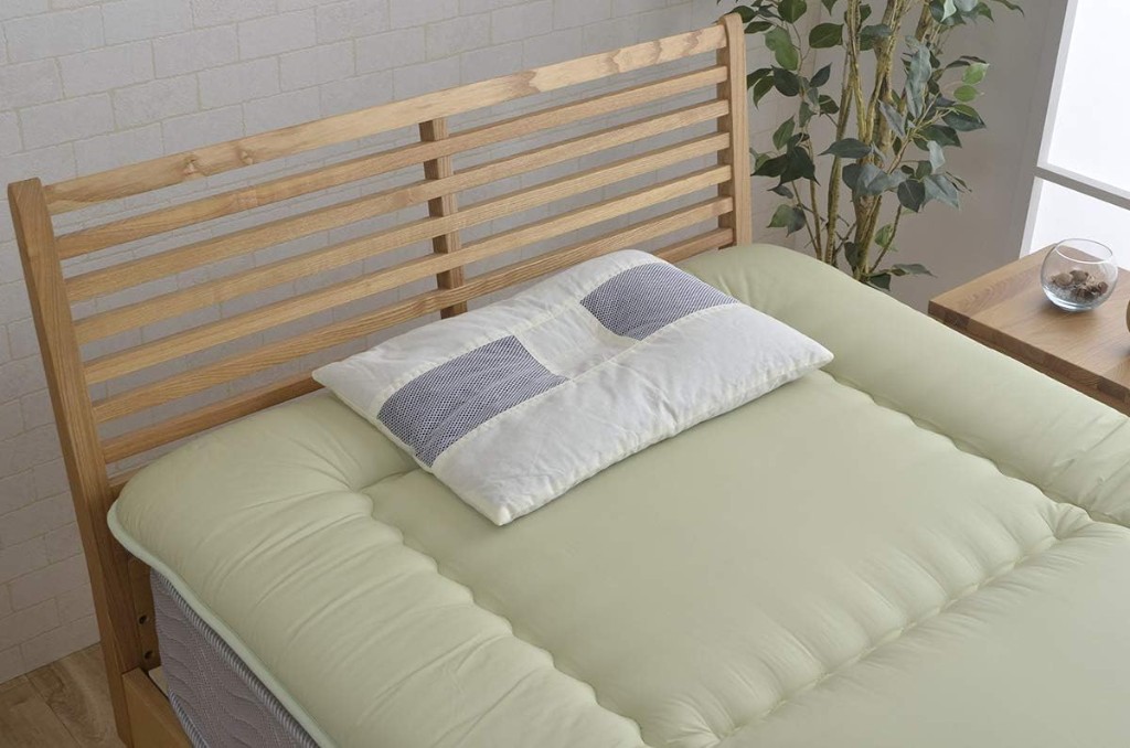 Charcoal Pipe Pillow on a bed — 14×20 in, made in Japan